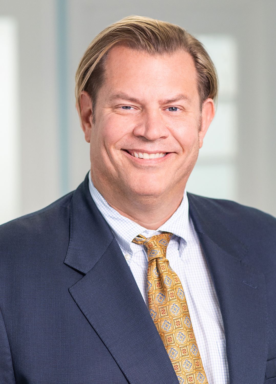 Professional man smiling in a suit.