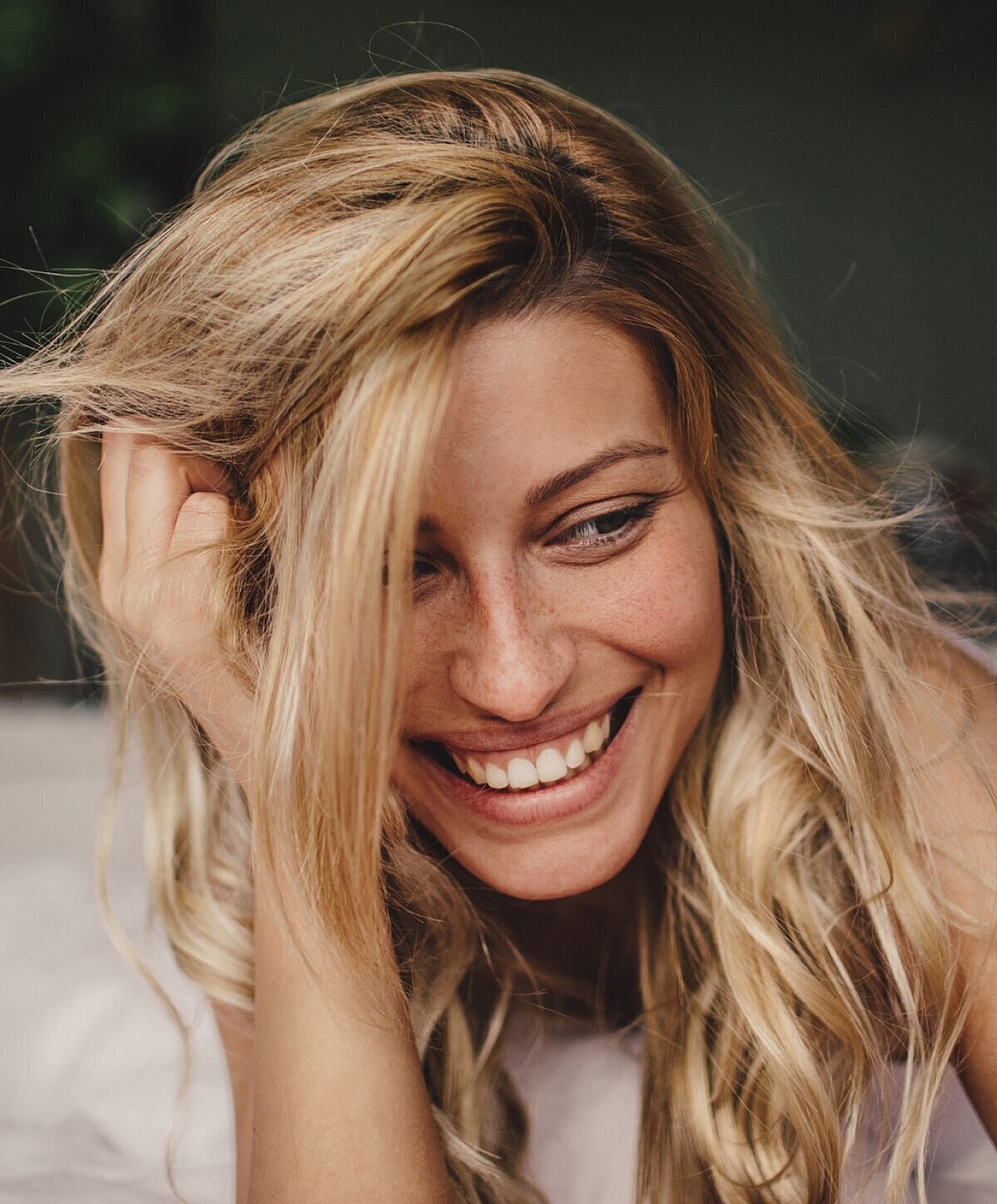 Smiling woman with long, wavy blonde hair.