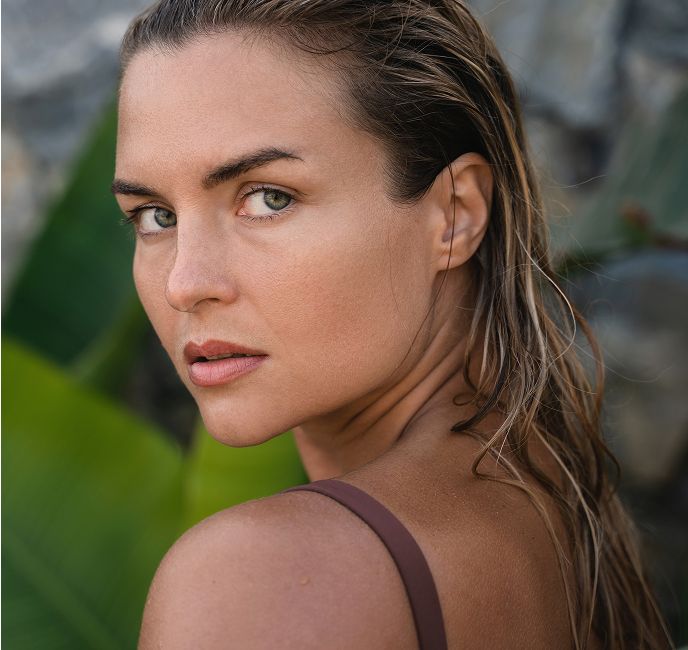 Portrait of a woman looking over her shoulder.