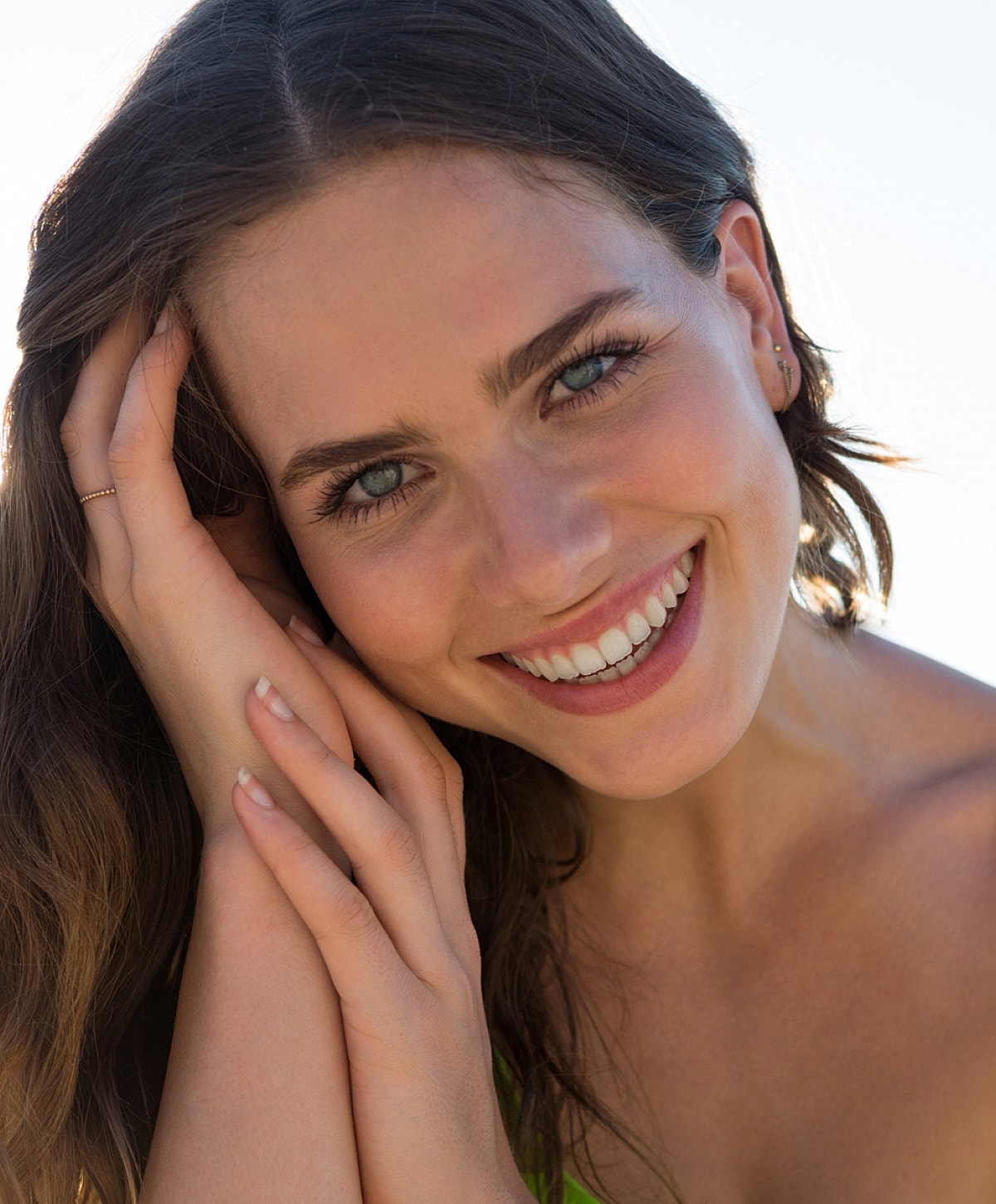 Close-up of a woman’s face, thoughtful expression.
