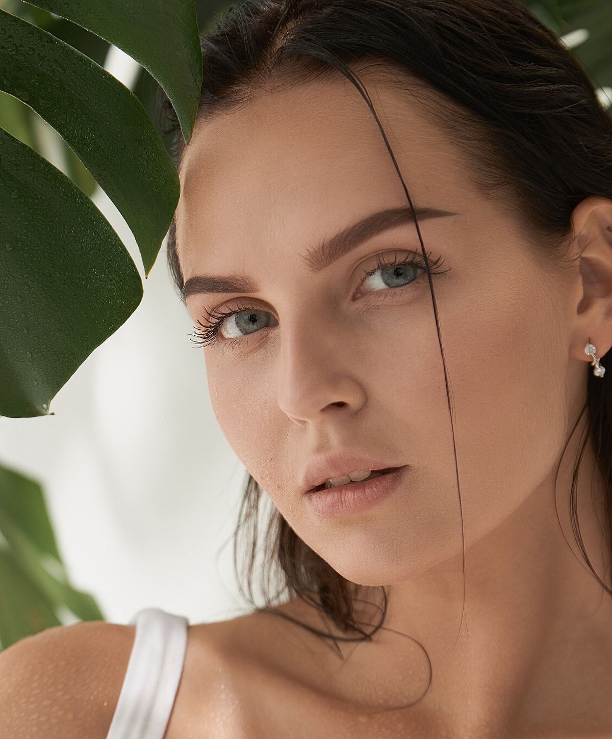 Woman's portrait with greenery background and natural light.