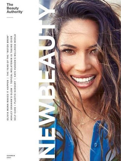 Magazine cover featuring a smiling woman with long hair.