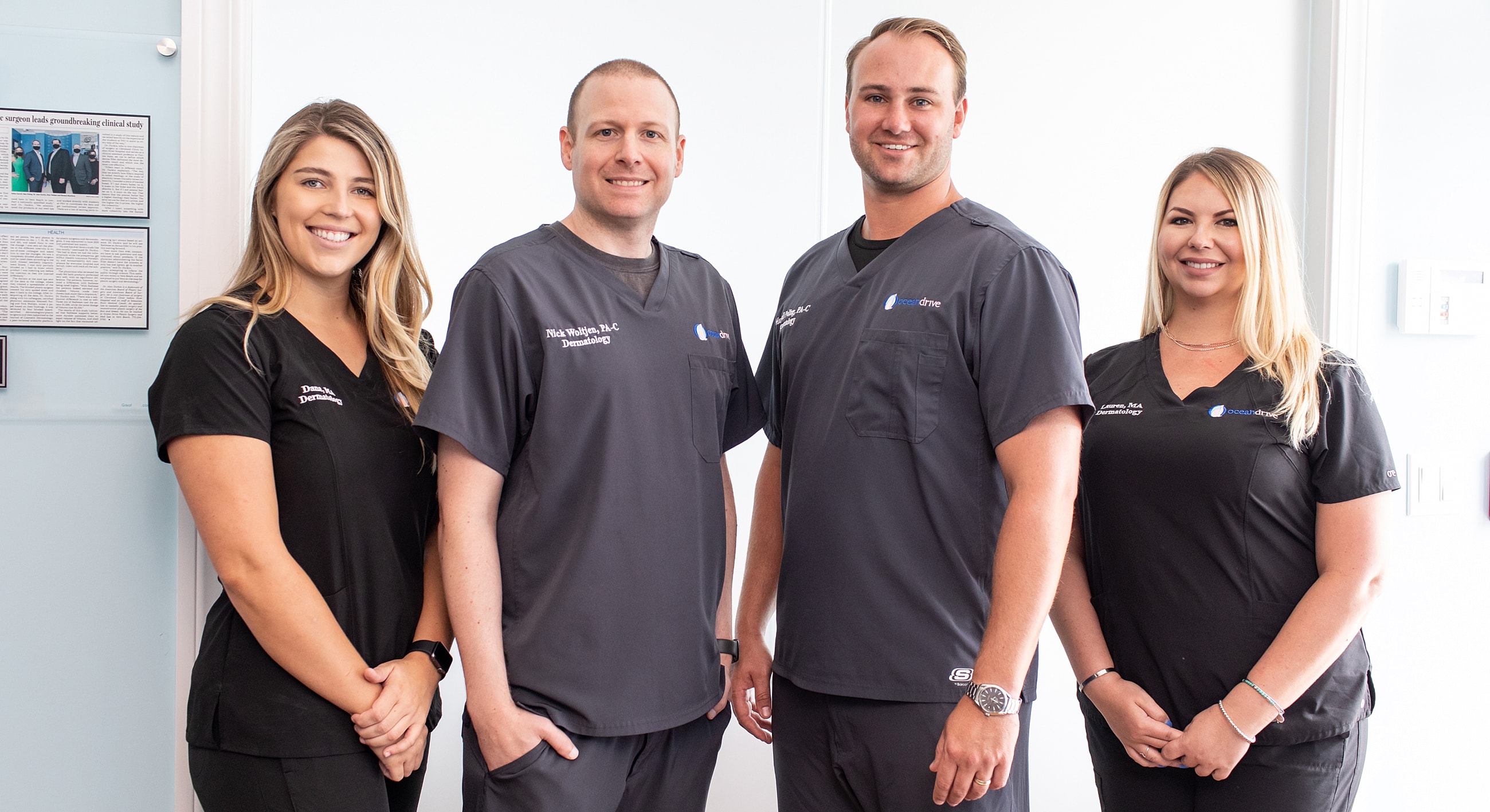 Medical team posing together in scrubs.