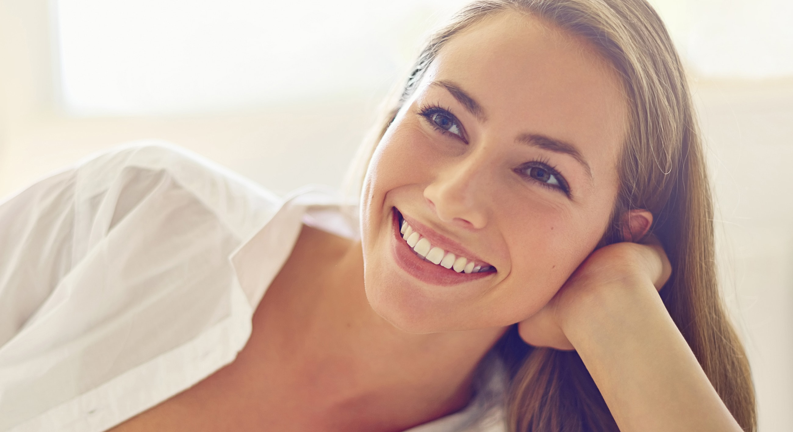 Smiling woman with long hair enjoying herself.