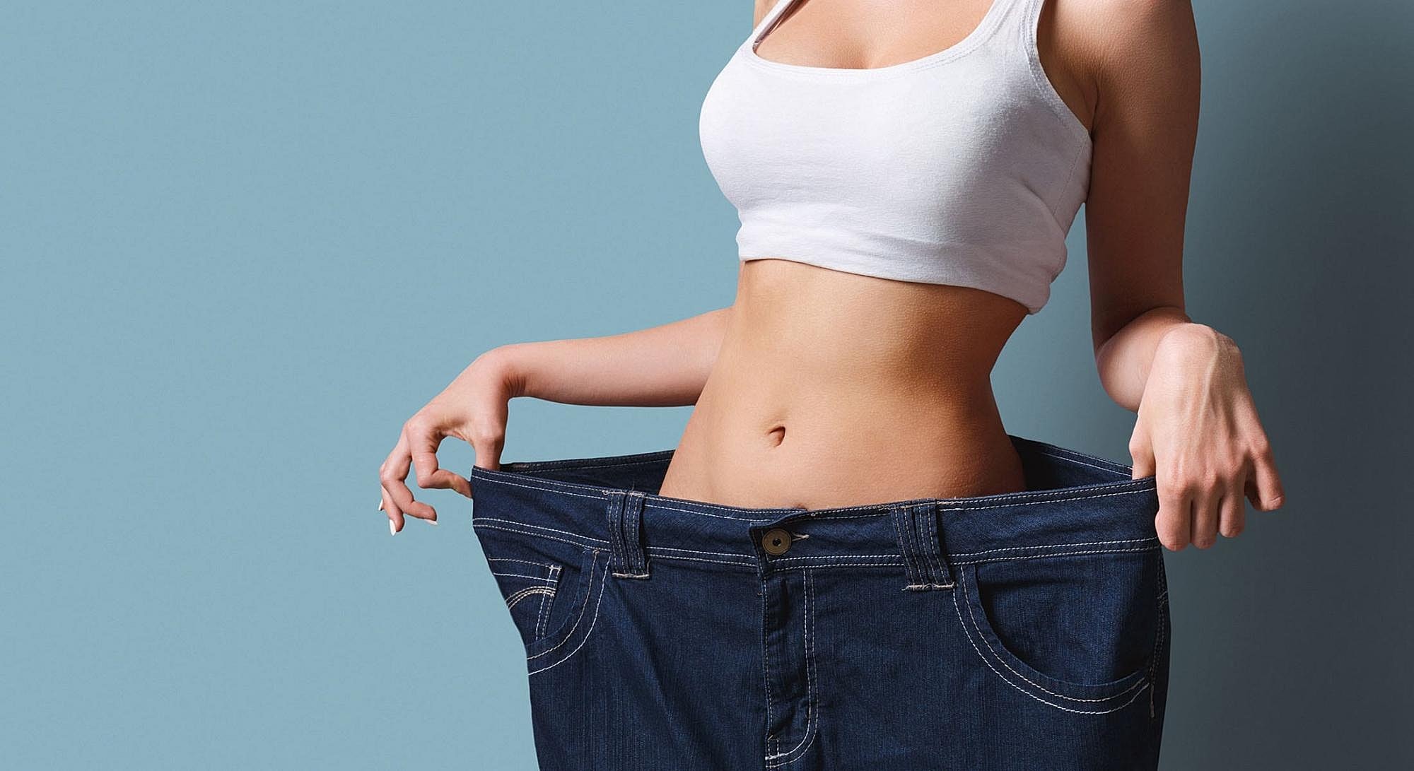 Weight loss success with oversized jeans illustration.